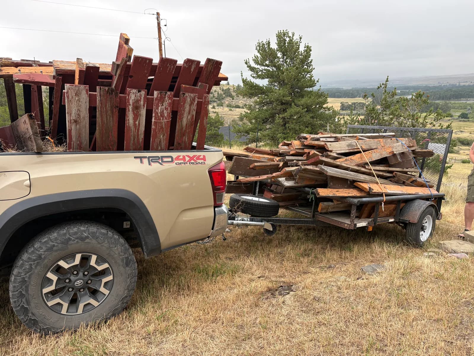 Wren's Junk Removal truck and trailer loaded with reclaimed barn wood on a job in the Gallatin Valley